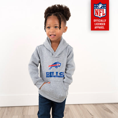  Cute little girl wearing a gray hoodie with the Buffalo Bills logo, paired with jeans, standing confidently against a white background. Shop officially licensed NFL apparel now included in the $5 Frenzy Sale!