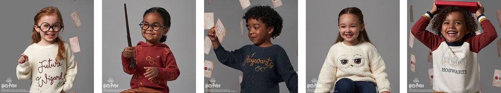 Four children wearing Harry Potter clothing joyfully hold up colorful cards, with one child smiling brightly at the camera, showcasing their excitement 