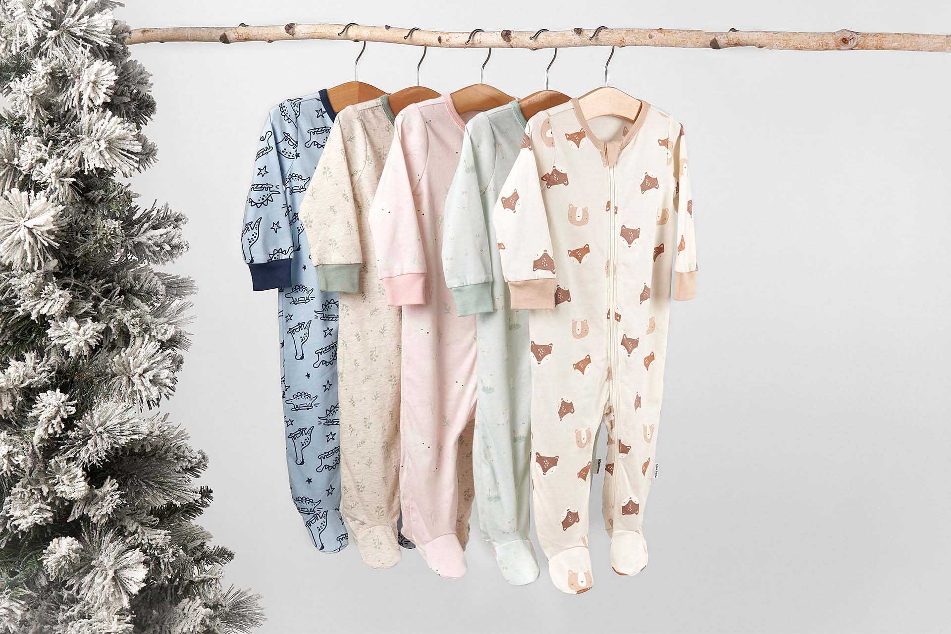 Shop our selection of cozy holiday-themed baby sleepwear, showcasing festive patterns like snowflakes and stripes. Ideal for keeping little ones snug and stylish during the holiday season.