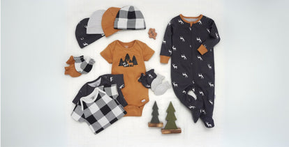  A display of curated baby gift sets with neatly arranged clothing, toys, and essentials in soft, neutral colors, designed to make gifting simple and special. Click to shop gift sets.